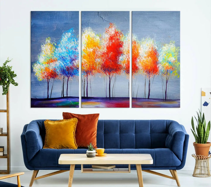 A triptych of the Abstract Colorful Trees Wall Art Canvas Print, gallery-wrapped on museum-quality canvas, adorns the wall.