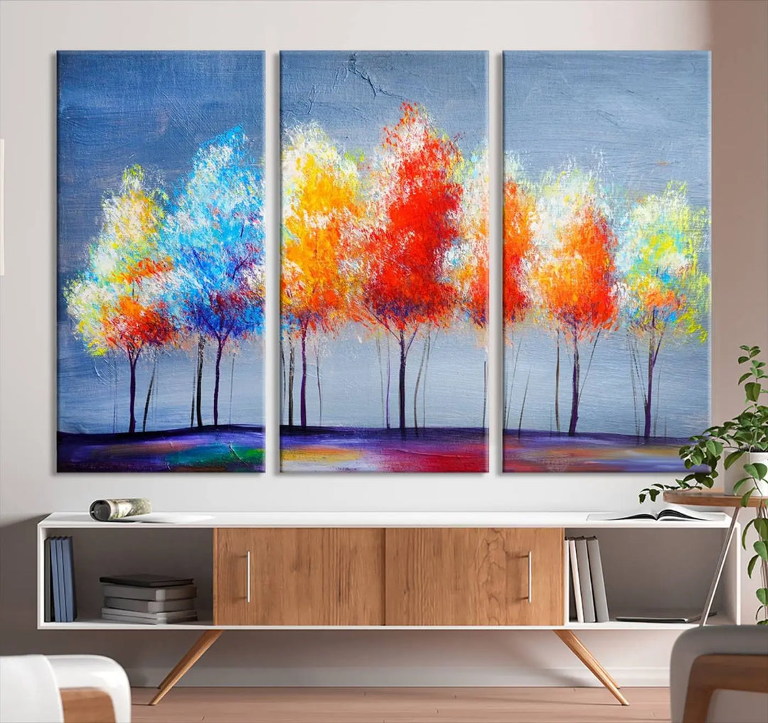 A triptych of the Abstract Colorful Trees Wall Art Canvas Print, gallery-wrapped on museum-quality canvas, adorns the wall.