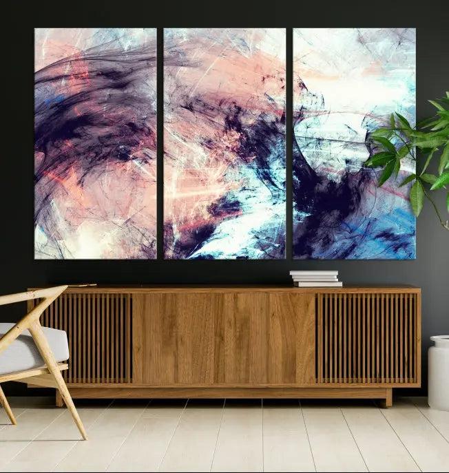 The Abstract Colors Wall Art Canvas Print features a triptych design with swirling purple, pink, and blue hues. This museum-quality piece on polycotton canvas is expertly hand-assembled and comes ready to hang.