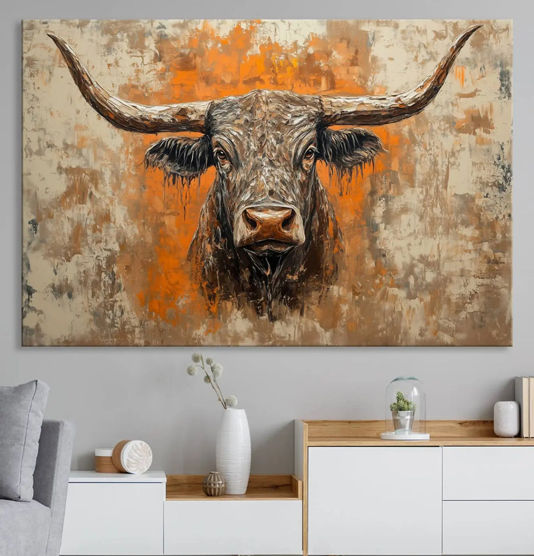 The Abstract Cow Longhorn Bull Wall Art Canvas Print, also known as Rustic Texas Western Cattle Artwork, captures the essence of rustic wall decor with its depiction of a longhorn bull with distinctive, curved horns against a textured, orange and beige abstract background. It's an ideal choice for introducing nature-inspired elements to any environment.