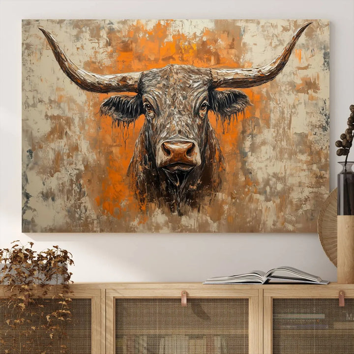 The Abstract Cow Longhorn Bull Wall Art Canvas Print, also known as Rustic Texas Western Cattle Artwork, captures the essence of rustic wall decor with its depiction of a longhorn bull with distinctive, curved horns against a textured, orange and beige abstract background. It's an ideal choice for introducing nature-inspired elements to any environment.