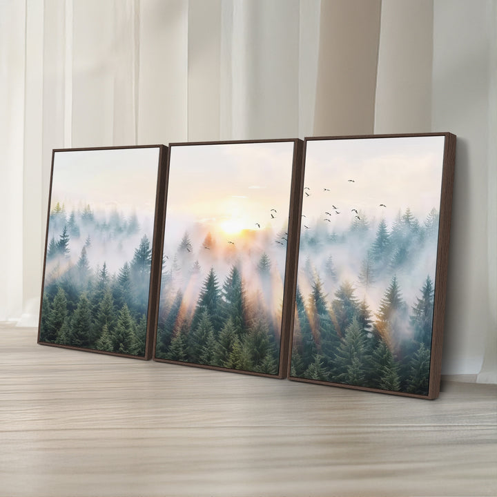 Misty Pine Forest Wall Art: A depiction of sunrise over foggy trees and birds against a bright sky; a framed woodland scene ideal for home or office decor.