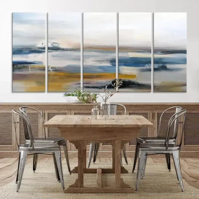 A captivating 3-panel abstract landscape wall art in modern blue, gold, and white hues graces the dark wall, enhancing the space with a touch of contemporary decor.