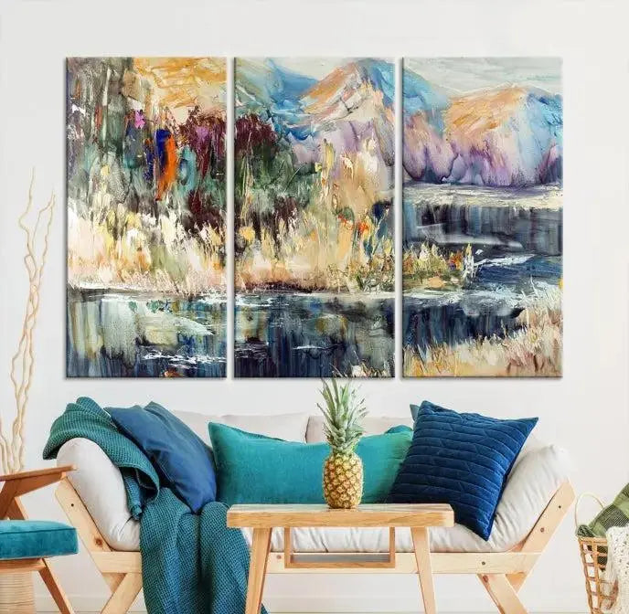 A vibrant Abstract Landscape Waterfall Canvas Art adorns the wall in this cozy living room. This 3-panel large wall art enhances the inviting space's vivid collection. This premium quality, ready-to-hang print is perfect for a living room, office, or lounge.