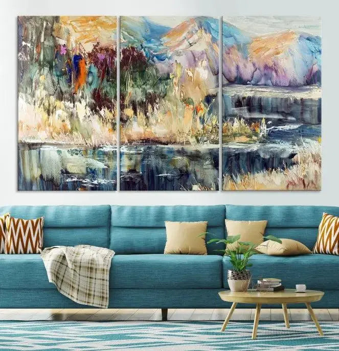 A vibrant Abstract Landscape Waterfall Canvas Art adorns the wall in this cozy living room. This 3-panel large wall art enhances the inviting space's vivid collection. This premium quality, ready-to-hang print is perfect for a living room, office, or lounge.