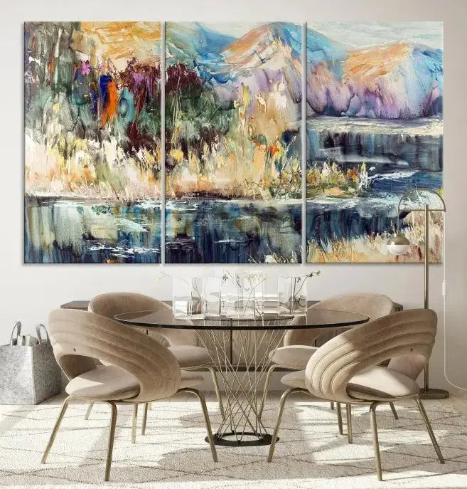 A vibrant Abstract Landscape Waterfall Canvas Art adorns the wall in this cozy living room. This 3-panel large wall art enhances the inviting space's vivid collection. This premium quality, ready-to-hang print is perfect for a living room, office, or lounge.