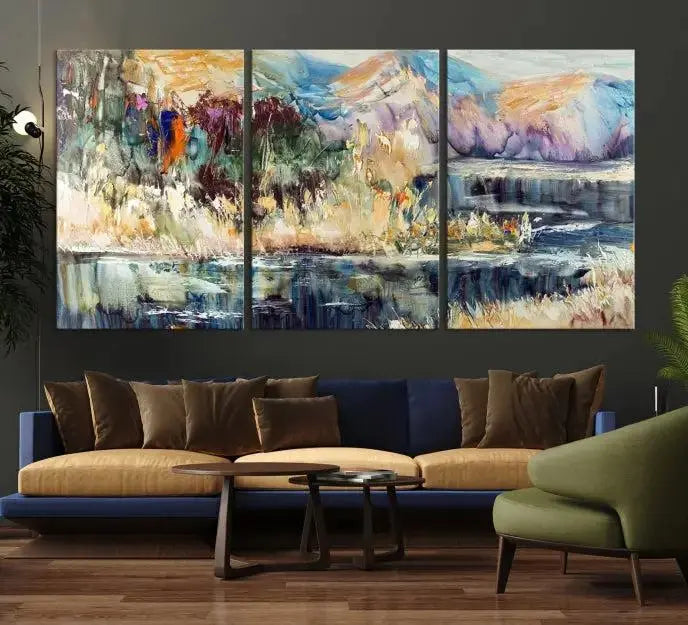 A vibrant Abstract Landscape Waterfall Canvas Art adorns the wall in this cozy living room. This 3-panel large wall art enhances the inviting space's vivid collection. This premium quality, ready-to-hang print is perfect for a living room, office, or lounge.