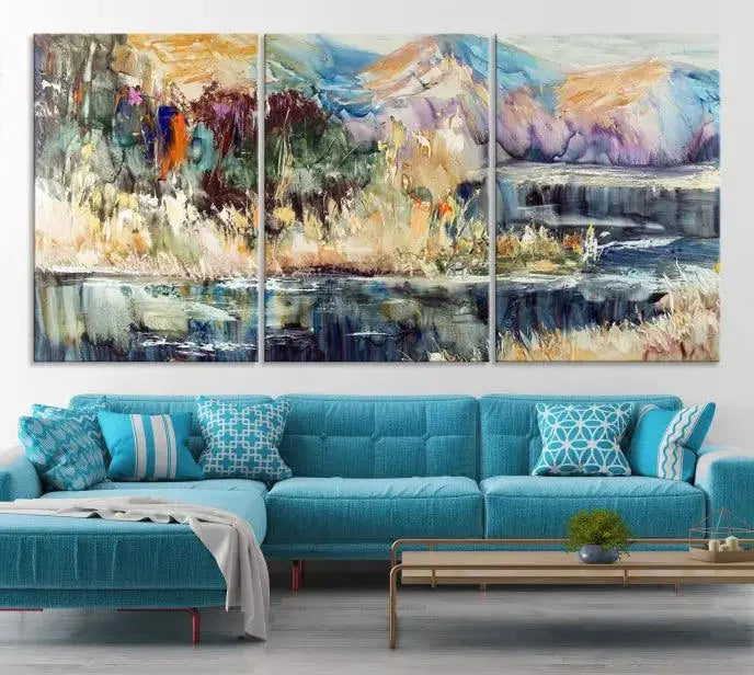 A vibrant Abstract Landscape Waterfall Canvas Art adorns the wall in this cozy living room. This 3-panel large wall art enhances the inviting space's vivid collection. This premium quality, ready-to-hang print is perfect for a living room, office, or lounge.