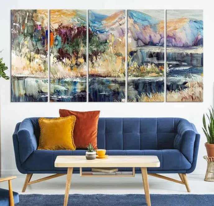 A vibrant Abstract Landscape Waterfall Canvas Art adorns the wall in this cozy living room. This 3-panel large wall art enhances the inviting space's vivid collection. This premium quality, ready-to-hang print is perfect for a living room, office, or lounge.