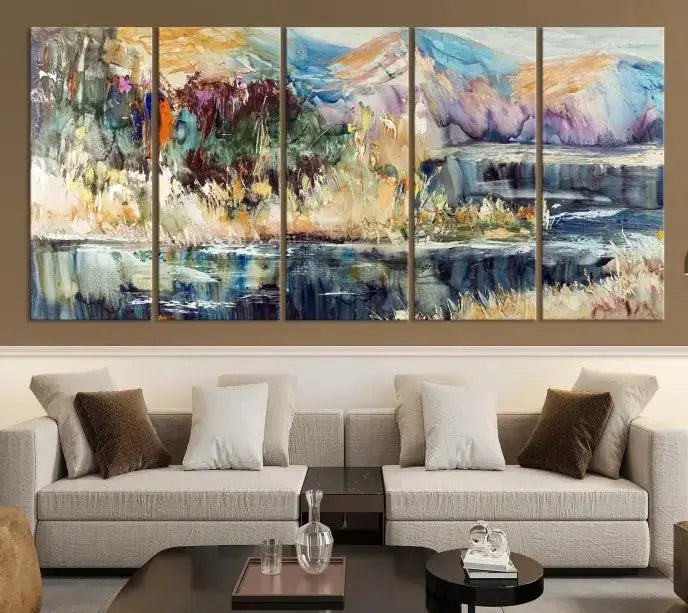 A vibrant Abstract Landscape Waterfall Canvas Art adorns the wall in this cozy living room. This 3-panel large wall art enhances the inviting space's vivid collection. This premium quality, ready-to-hang print is perfect for a living room, office, or lounge.