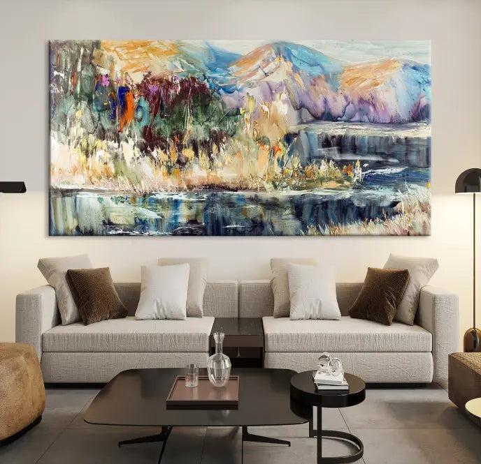 A vibrant Abstract Landscape Waterfall Canvas Art adorns the wall in this cozy living room. This 3-panel large wall art enhances the inviting space's vivid collection. This premium quality, ready-to-hang print is perfect for a living room, office, or lounge.