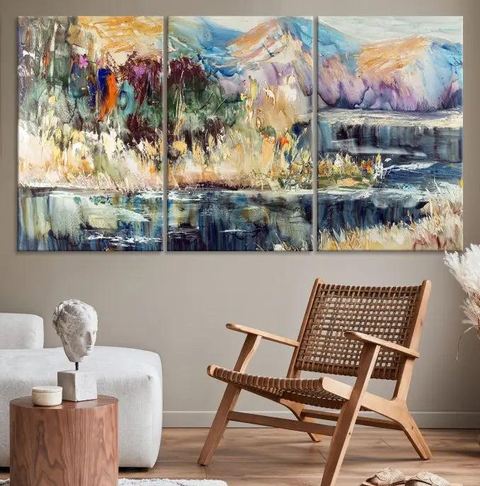 A vibrant Abstract Landscape Waterfall Canvas Art adorns the wall in this cozy living room. This 3-panel large wall art enhances the inviting space's vivid collection. This premium quality, ready-to-hang print is perfect for a living room, office, or lounge.