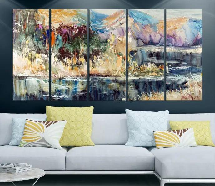 A vibrant Abstract Landscape Waterfall Canvas Art adorns the wall in this cozy living room. This 3-panel large wall art enhances the inviting space's vivid collection. This premium quality, ready-to-hang print is perfect for a living room, office, or lounge.