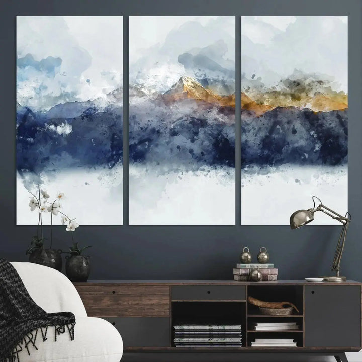 A stunning Abstract Mountain Range Art Canvas Print in a 3-panel watercolor landscape design is displayed on the wall.