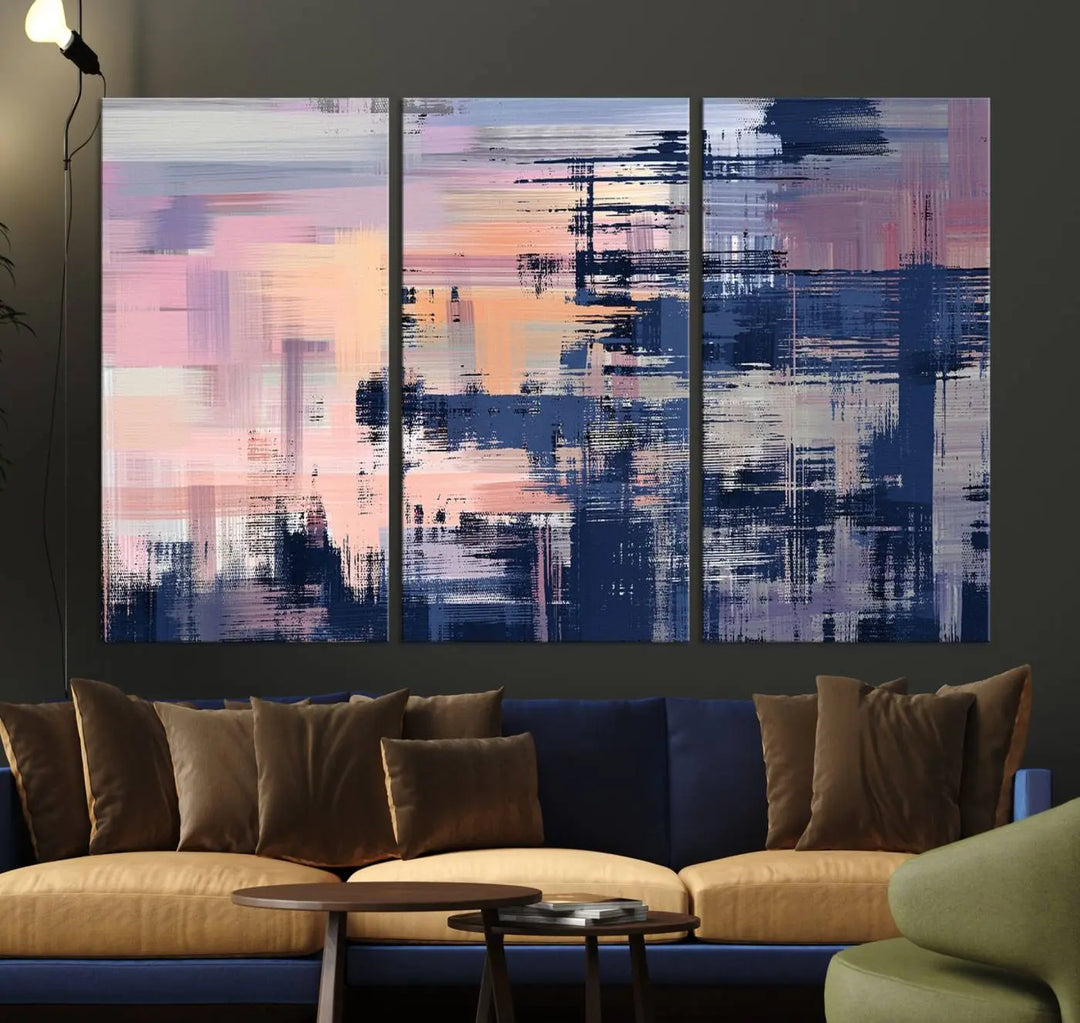 The Abstract Painting Wall Art Canvas Print Split Canvas Art, featuring pink, peach, and navy blue tones, decorates the wall. This museum-quality canvas is equipped with a UV-protective coating to preserve its vivid colors and comes ready to hang for your convenience.