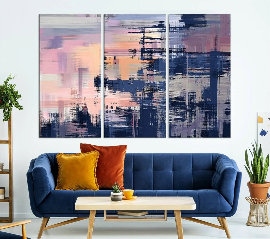 The Abstract Painting Wall Art Canvas Print Split Canvas Art, featuring pink, peach, and navy blue tones, decorates the wall. This museum-quality canvas is equipped with a UV-protective coating to preserve its vivid colors and comes ready to hang for your convenience.