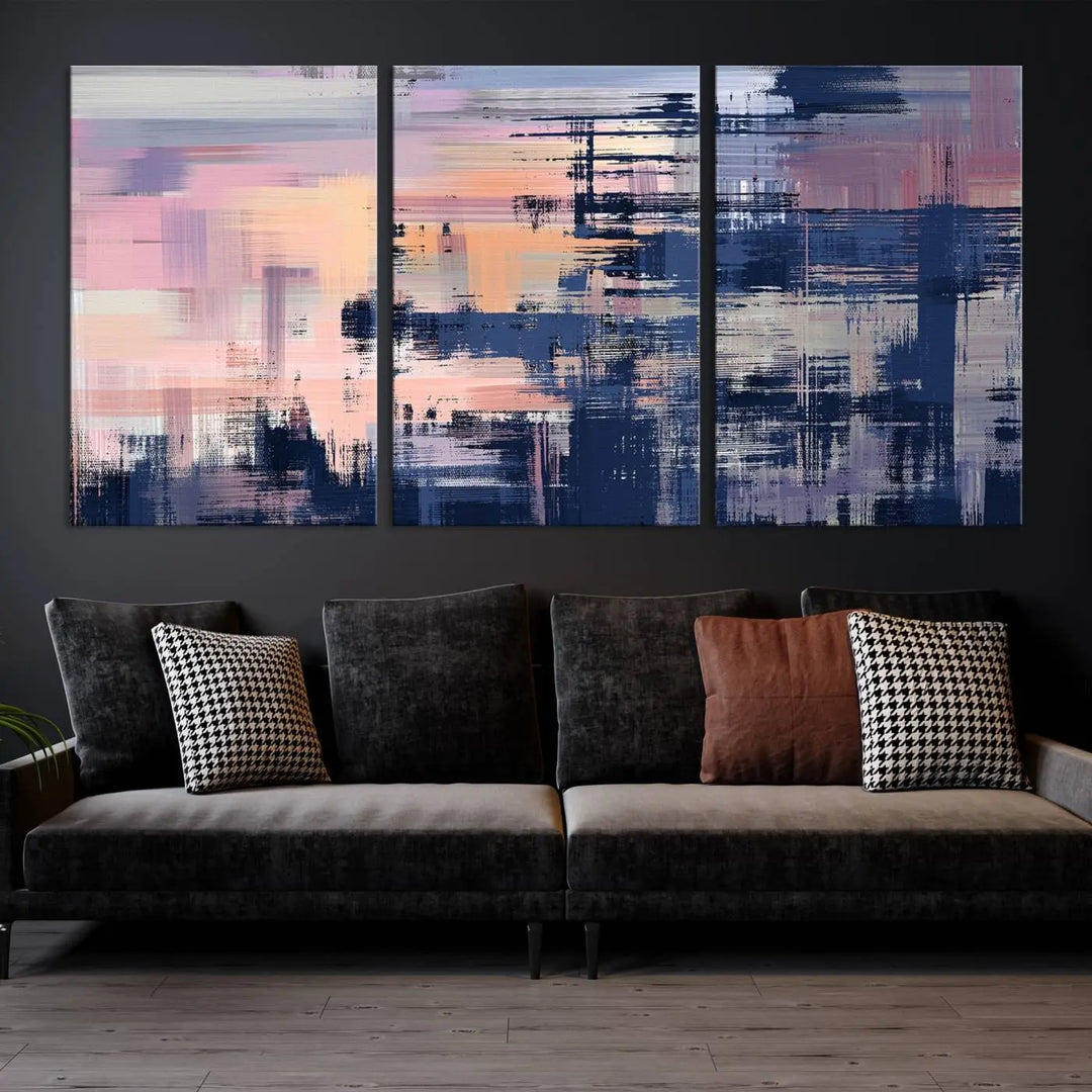 The Abstract Painting Wall Art Canvas Print Split Canvas Art, featuring pink, peach, and navy blue tones, decorates the wall. This museum-quality canvas is equipped with a UV-protective coating to preserve its vivid colors and comes ready to hang for your convenience.