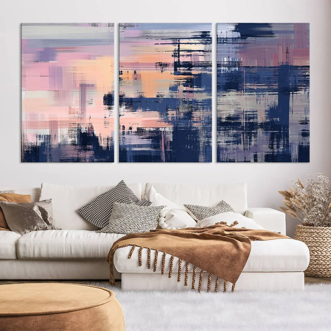 The Abstract Painting Wall Art Canvas Print Split Canvas Art, featuring pink, peach, and navy blue tones, decorates the wall. This museum-quality canvas is equipped with a UV-protective coating to preserve its vivid colors and comes ready to hang for your convenience.