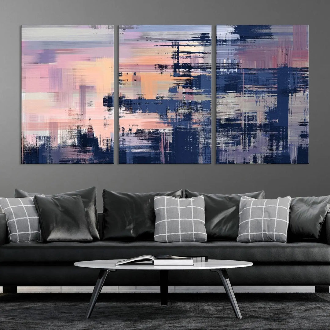 The Abstract Painting Wall Art Canvas Print Split Canvas Art, featuring pink, peach, and navy blue tones, decorates the wall. This museum-quality canvas is equipped with a UV-protective coating to preserve its vivid colors and comes ready to hang for your convenience.