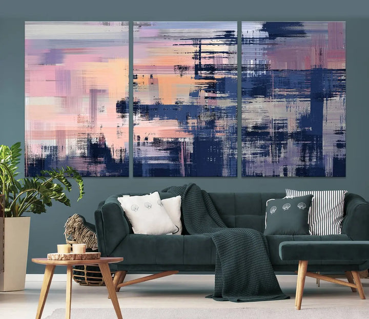 The Abstract Painting Wall Art Canvas Print Split Canvas Art, featuring pink, peach, and navy blue tones, decorates the wall. This museum-quality canvas is equipped with a UV-protective coating to preserve its vivid colors and comes ready to hang for your convenience.