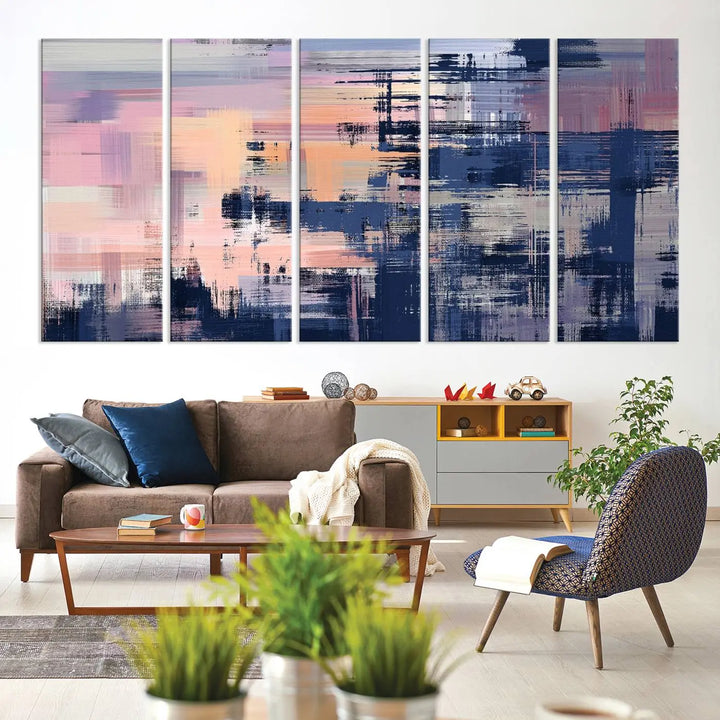 The Abstract Painting Wall Art Canvas Print Split Canvas Art, featuring pink, peach, and navy blue tones, decorates the wall. This museum-quality canvas is equipped with a UV-protective coating to preserve its vivid colors and comes ready to hang for your convenience.