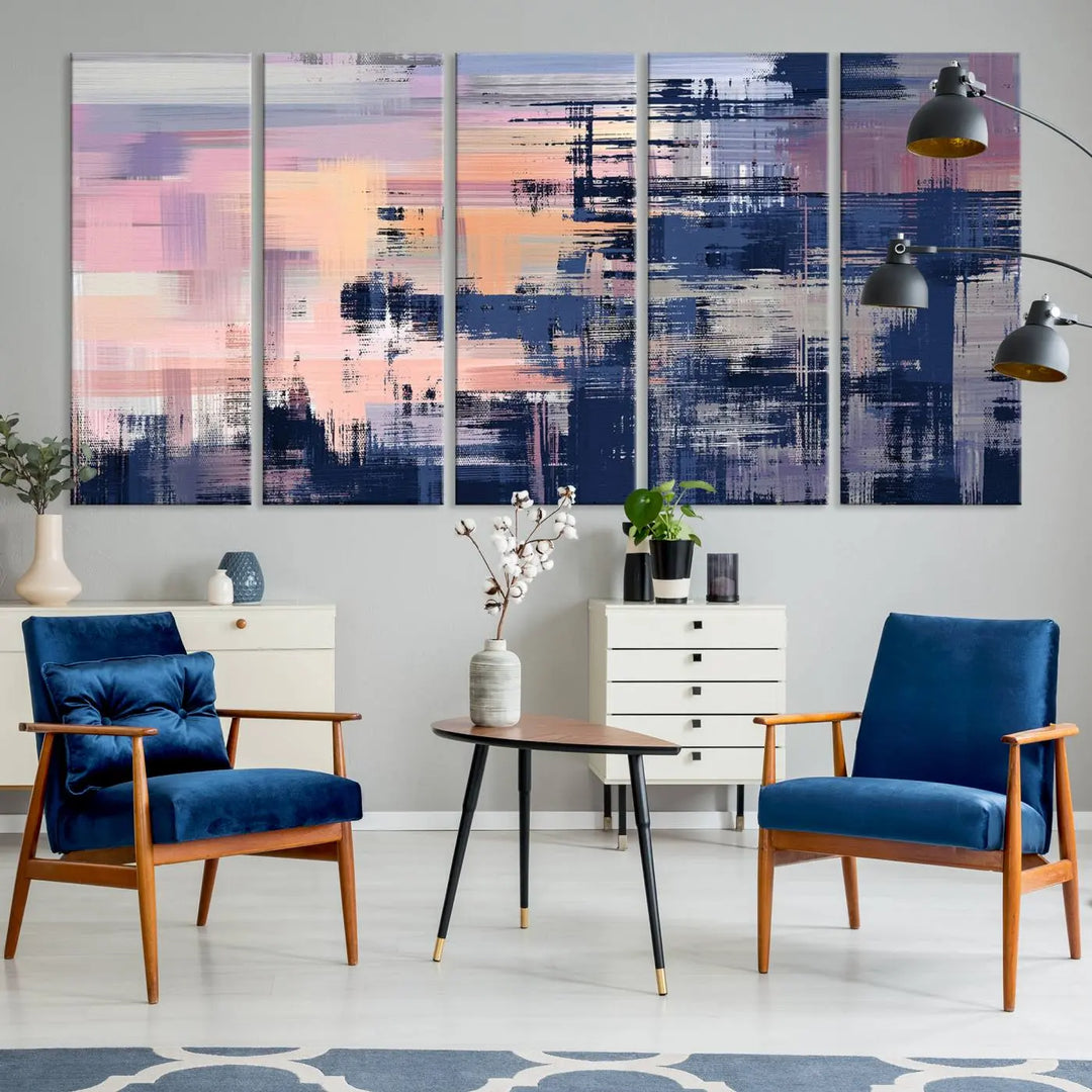 The Abstract Painting Wall Art Canvas Print Split Canvas Art, featuring pink, peach, and navy blue tones, decorates the wall. This museum-quality canvas is equipped with a UV-protective coating to preserve its vivid colors and comes ready to hang for your convenience.