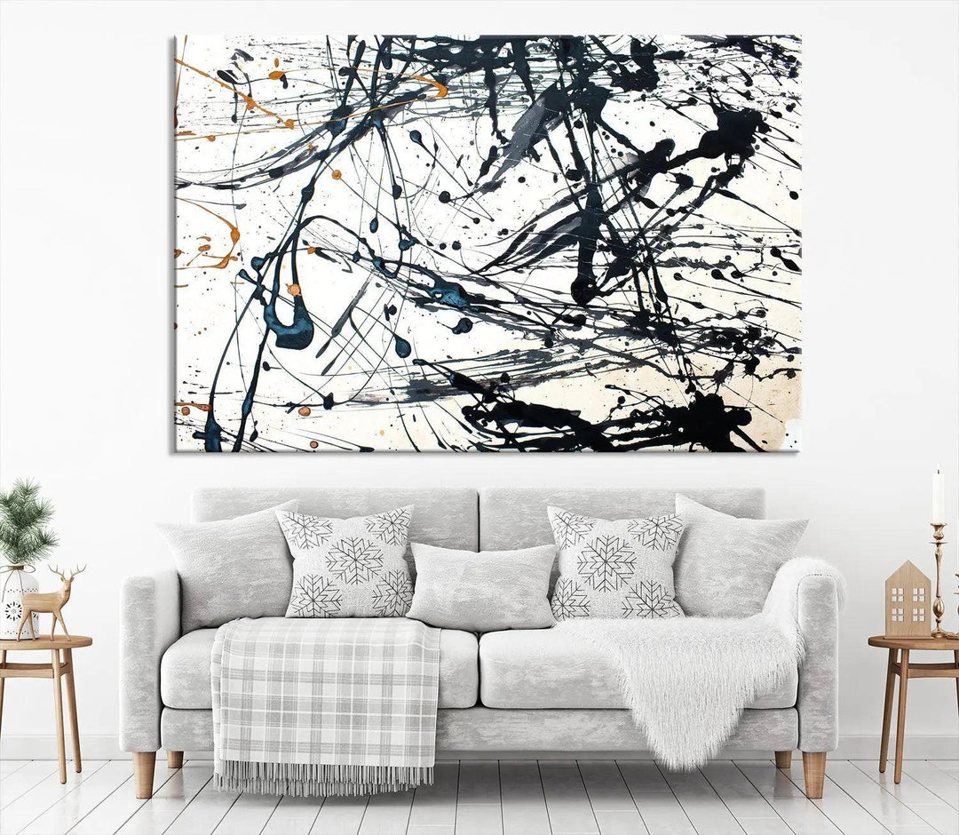 The Abstract Splash Wall Art Canvas Print, featuring a triptych design with blue and black splatters on a white background, is crafted on museum-quality canvas. It includes a UV-protective coating to maintain its vibrant appearance over time.