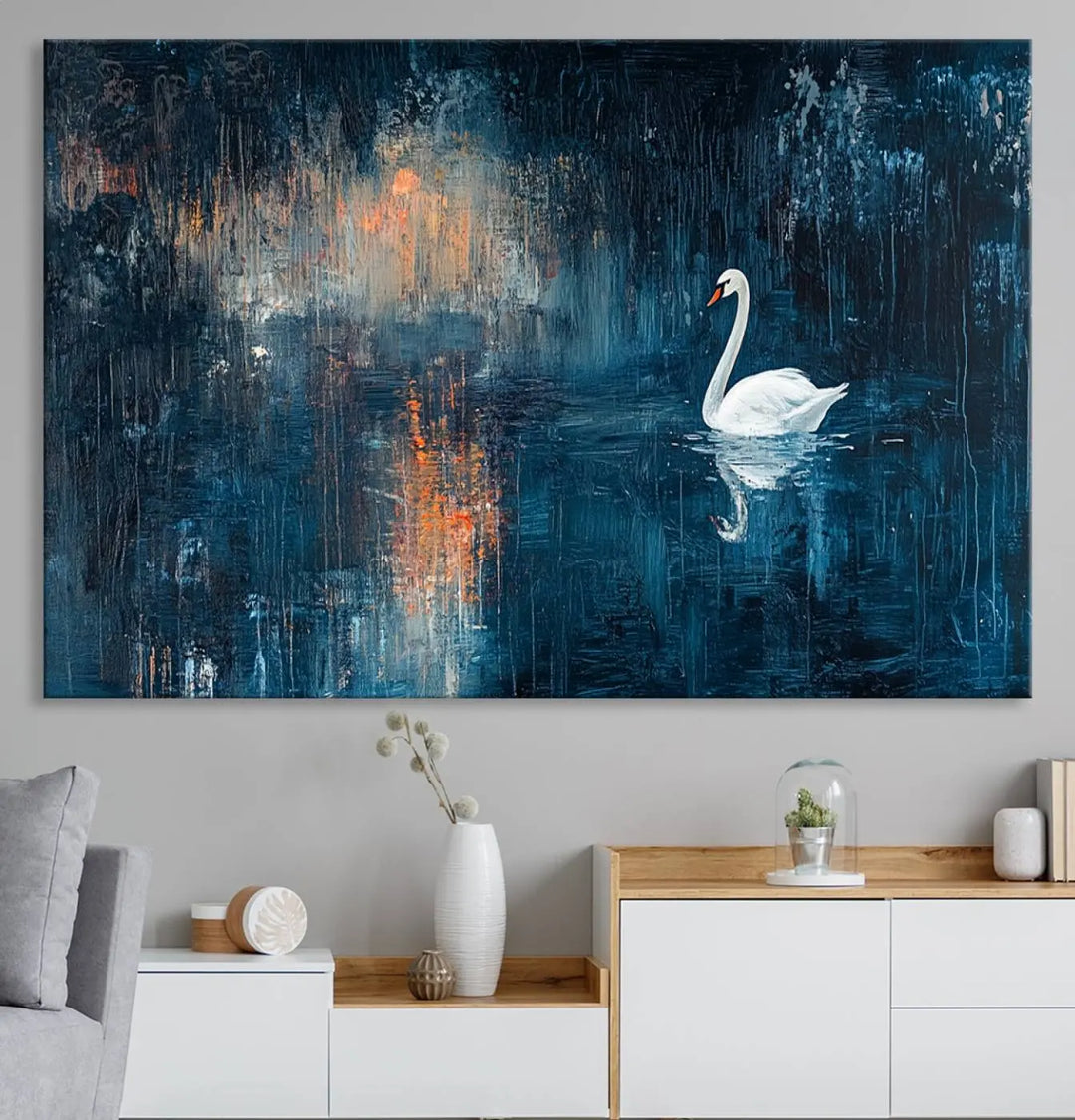 The Abstract Swan Wall Art is a captivating canvas print featuring a moody blue and orange swan on dark water, perfect for enhancing contemporary home decor.