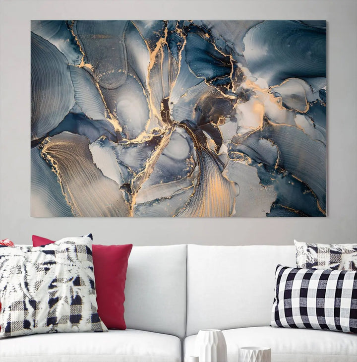 The Abstract Wall Art Canvas Print for Modern Home Decor is a striking feature in the modern living room. It showcases a blue and gold triptych design on museum-quality canvas, complete with a UV-protective coating to ensure long-lasting vibrancy.