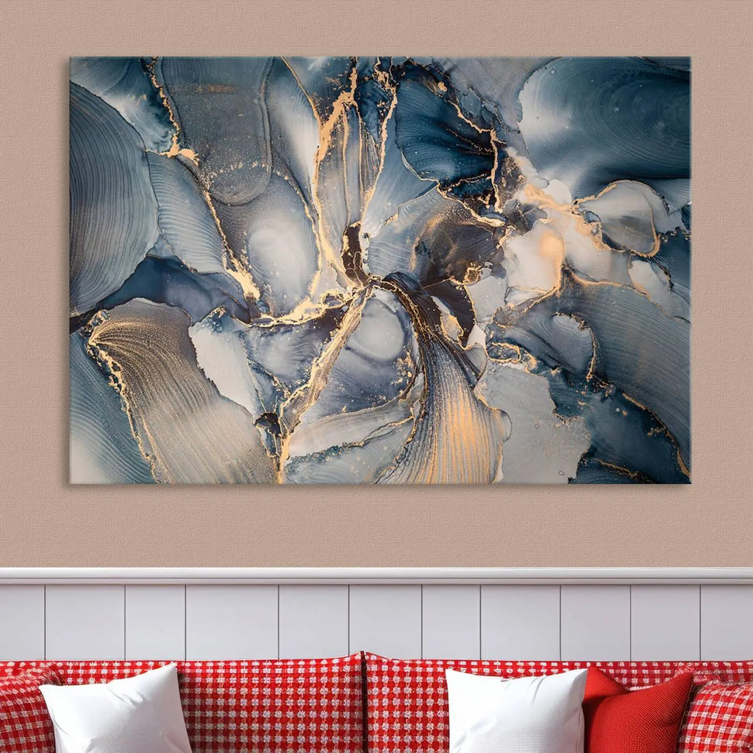 The Abstract Wall Art Canvas Print for Modern Home Decor is a striking feature in the modern living room. It showcases a blue and gold triptych design on museum-quality canvas, complete with a UV-protective coating to ensure long-lasting vibrancy.