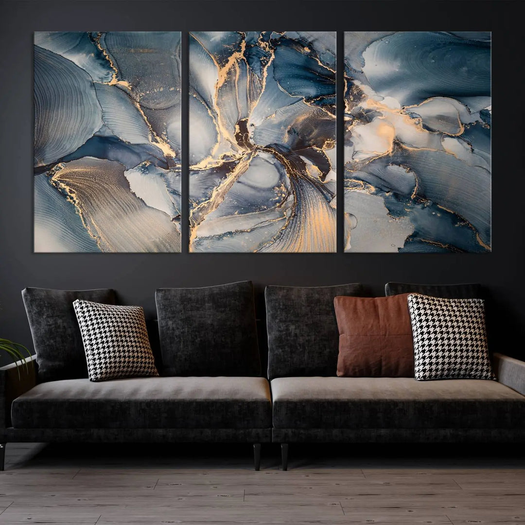 The Abstract Wall Art Canvas Print for Modern Home Decor is a striking feature in the modern living room. It showcases a blue and gold triptych design on museum-quality canvas, complete with a UV-protective coating to ensure long-lasting vibrancy.