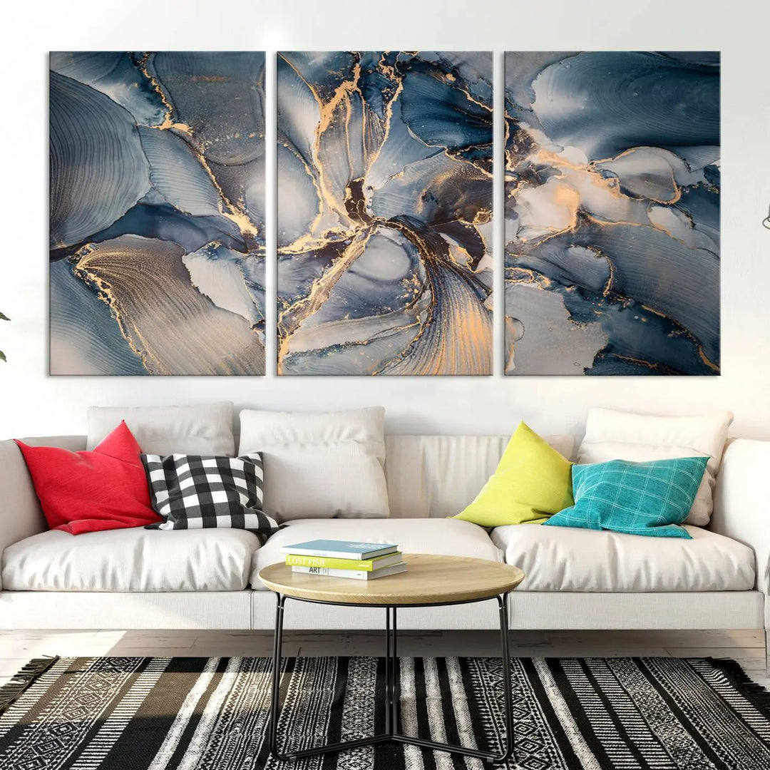 The Abstract Wall Art Canvas Print for Modern Home Decor is a striking feature in the modern living room. It showcases a blue and gold triptych design on museum-quality canvas, complete with a UV-protective coating to ensure long-lasting vibrancy.