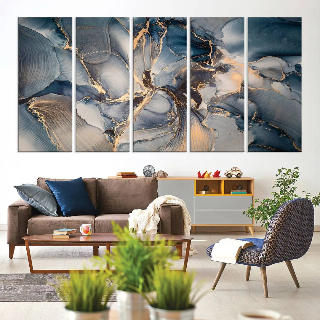 The Abstract Wall Art Canvas Print for Modern Home Decor is a striking feature in the modern living room. It showcases a blue and gold triptych design on museum-quality canvas, complete with a UV-protective coating to ensure long-lasting vibrancy.