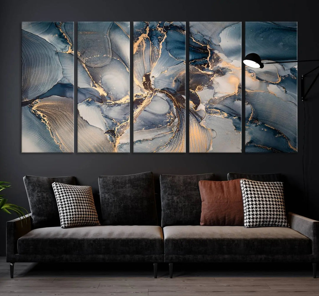 The Abstract Wall Art Canvas Print for Modern Home Decor is a striking feature in the modern living room. It showcases a blue and gold triptych design on museum-quality canvas, complete with a UV-protective coating to ensure long-lasting vibrancy.