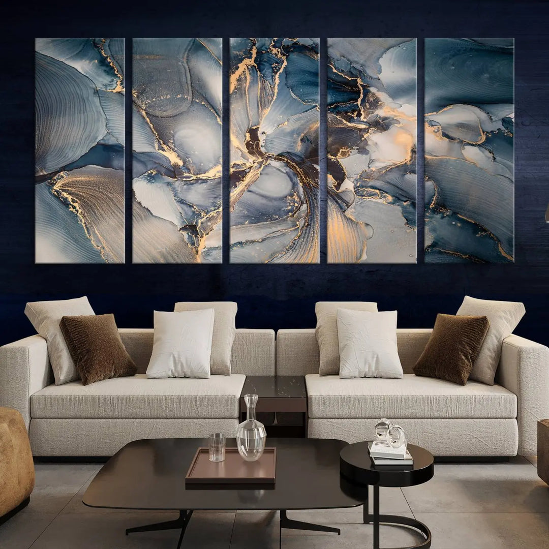 The Abstract Wall Art Canvas Print for Modern Home Decor is a striking feature in the modern living room. It showcases a blue and gold triptych design on museum-quality canvas, complete with a UV-protective coating to ensure long-lasting vibrancy.