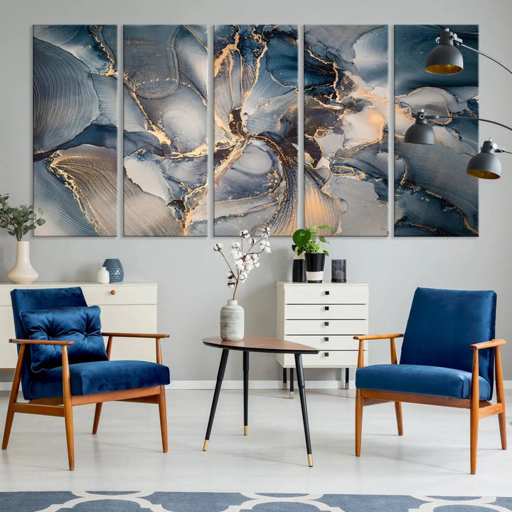 The Abstract Wall Art Canvas Print for Modern Home Decor is a striking feature in the modern living room. It showcases a blue and gold triptych design on museum-quality canvas, complete with a UV-protective coating to ensure long-lasting vibrancy.