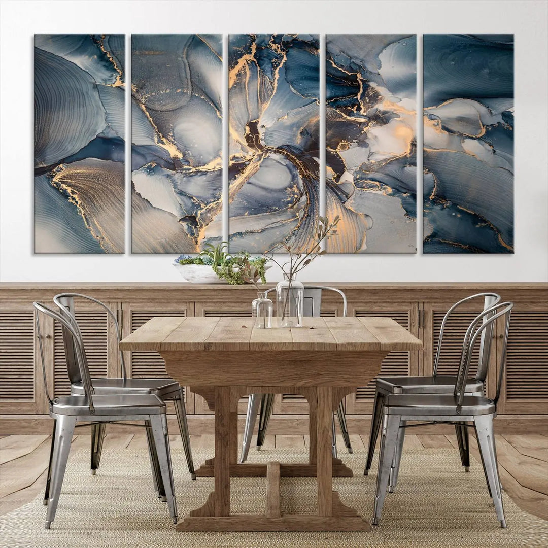 The Abstract Wall Art Canvas Print for Modern Home Decor is a striking feature in the modern living room. It showcases a blue and gold triptych design on museum-quality canvas, complete with a UV-protective coating to ensure long-lasting vibrancy.