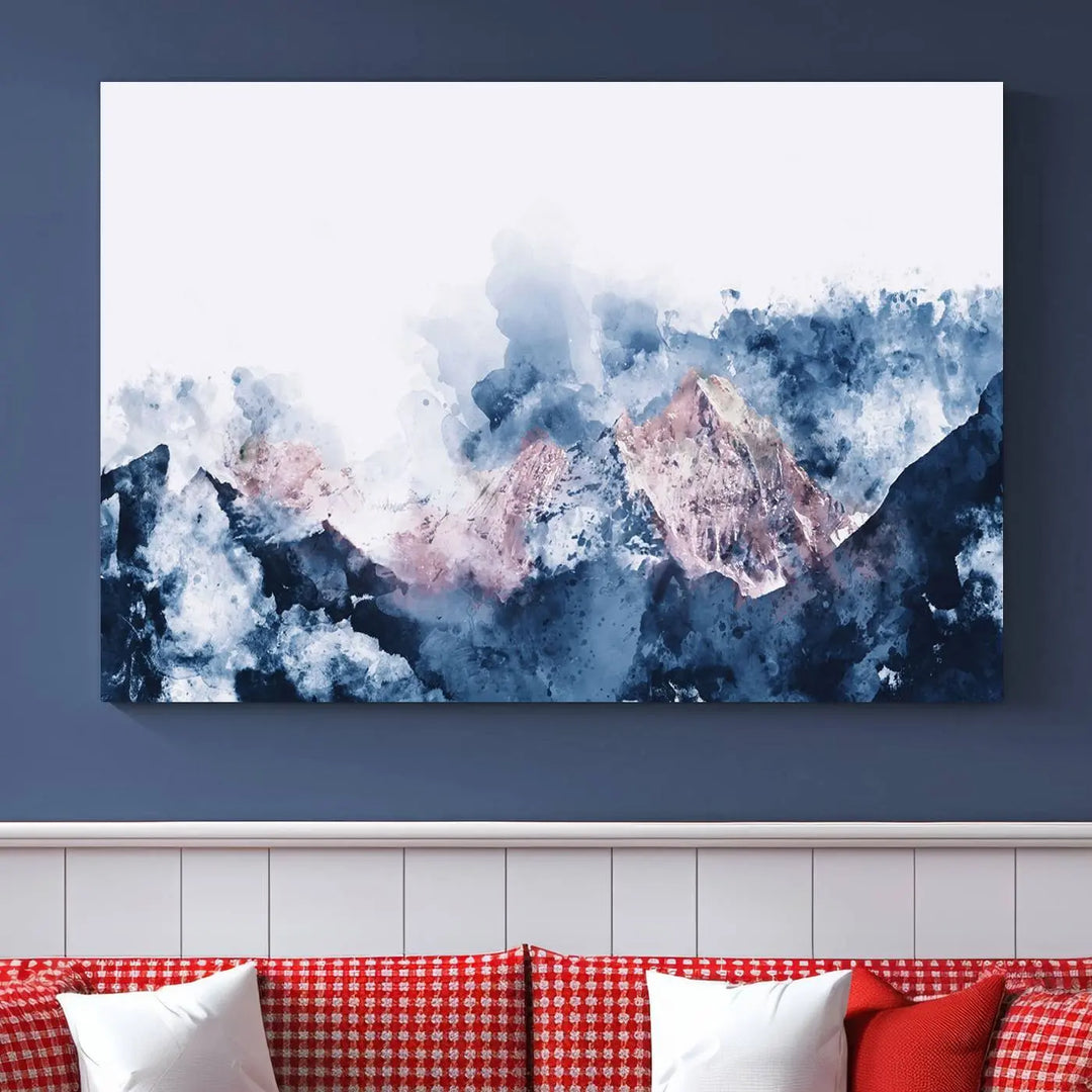 The modern living room features a framed triptych art on a dark wall, complemented by the Abstract Watercolor Mountain Landscape Art Canvas Print, which adds elegance and depth to the space.