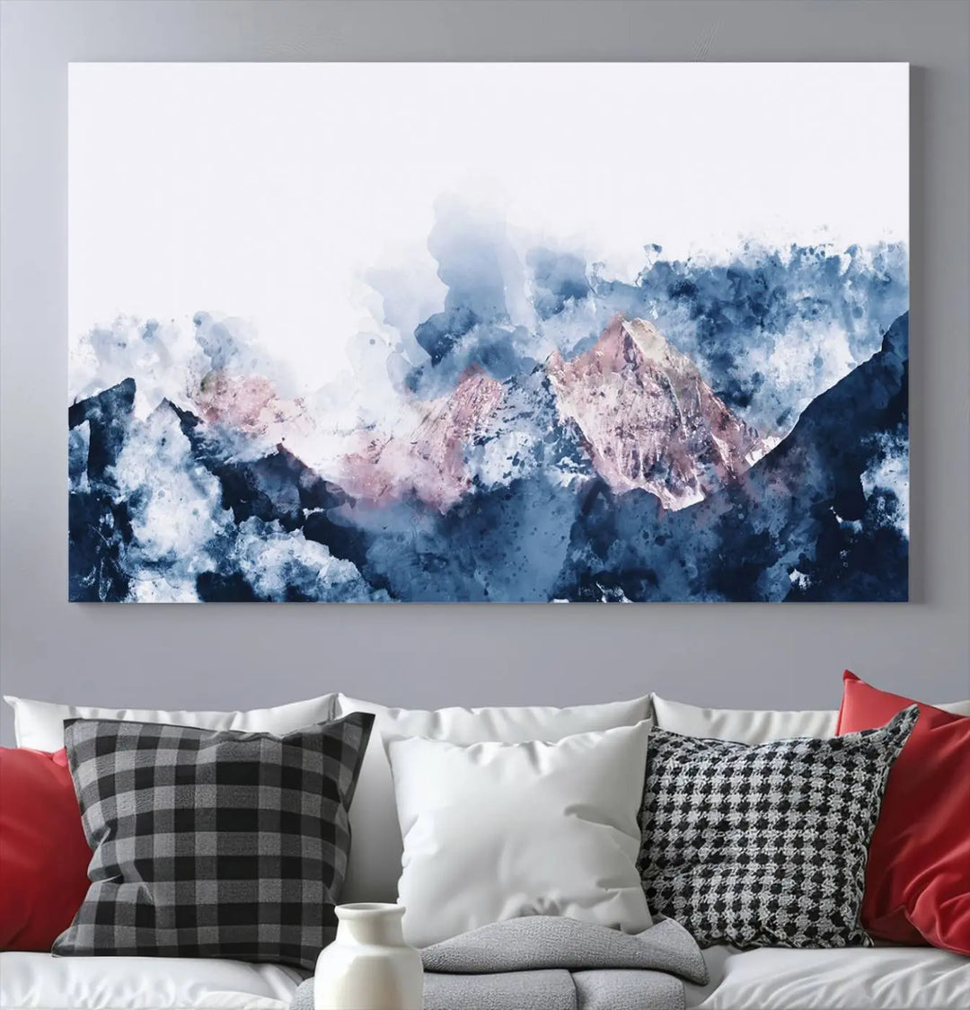 The modern living room features a framed triptych art on a dark wall, complemented by the Abstract Watercolor Mountain Landscape Art Canvas Print, which adds elegance and depth to the space.