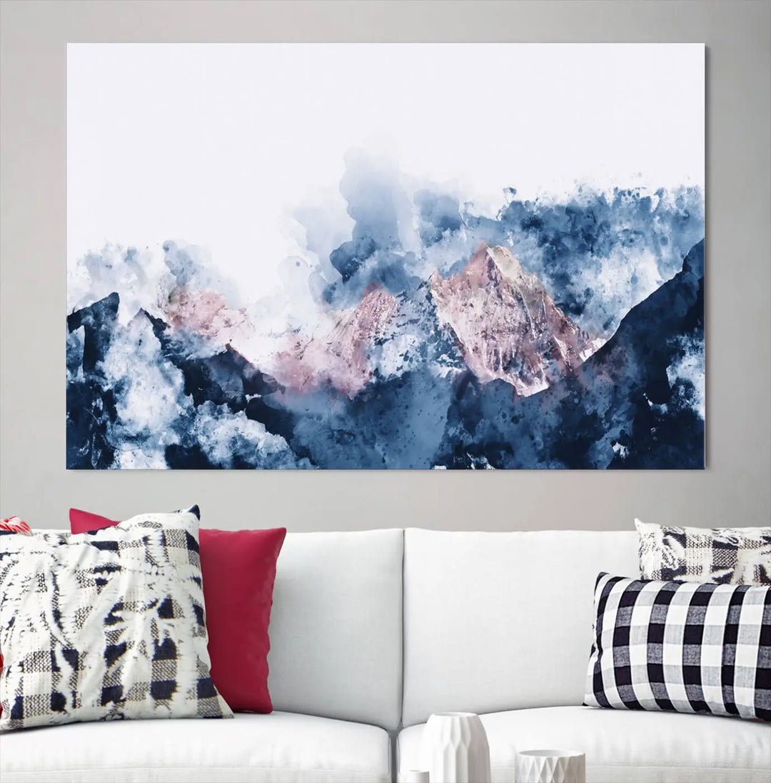 The modern living room features a framed triptych art on a dark wall, complemented by the Abstract Watercolor Mountain Landscape Art Canvas Print, which adds elegance and depth to the space.