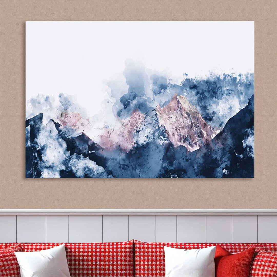 The modern living room features a framed triptych art on a dark wall, complemented by the Abstract Watercolor Mountain Landscape Art Canvas Print, which adds elegance and depth to the space.