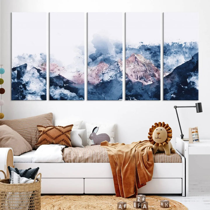 The modern living room features a framed triptych art on a dark wall, complemented by the Abstract Watercolor Mountain Landscape Art Canvas Print, which adds elegance and depth to the space.