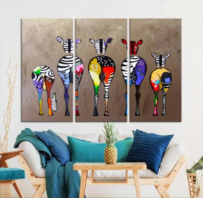 The Abstract Zebras Wall Art Canvas Print features a three-panel design of colorful zebra backs printed on museum-quality canvas. It comes ready to hang for easy installation and is protected with a UV-coating to maintain its vibrant hues.