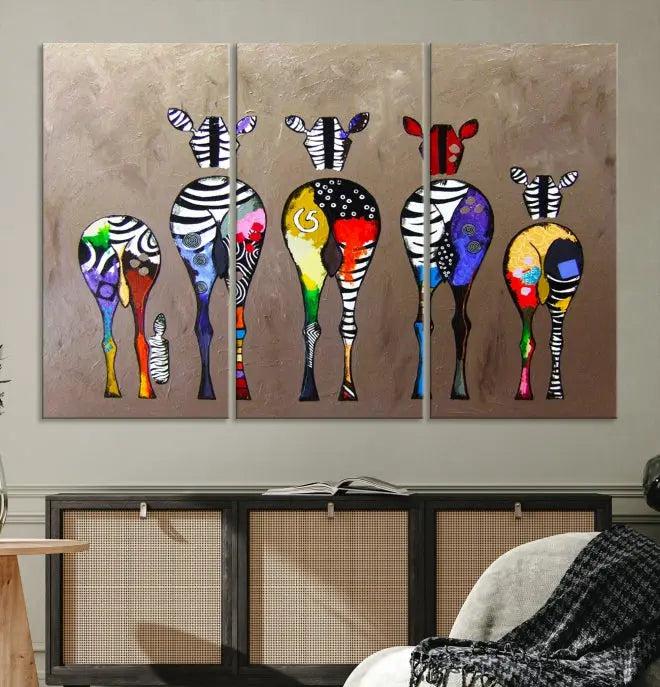 The Abstract Zebras Wall Art Canvas Print features a three-panel design of colorful zebra backs printed on museum-quality canvas. It comes ready to hang for easy installation and is protected with a UV-coating to maintain its vibrant hues.