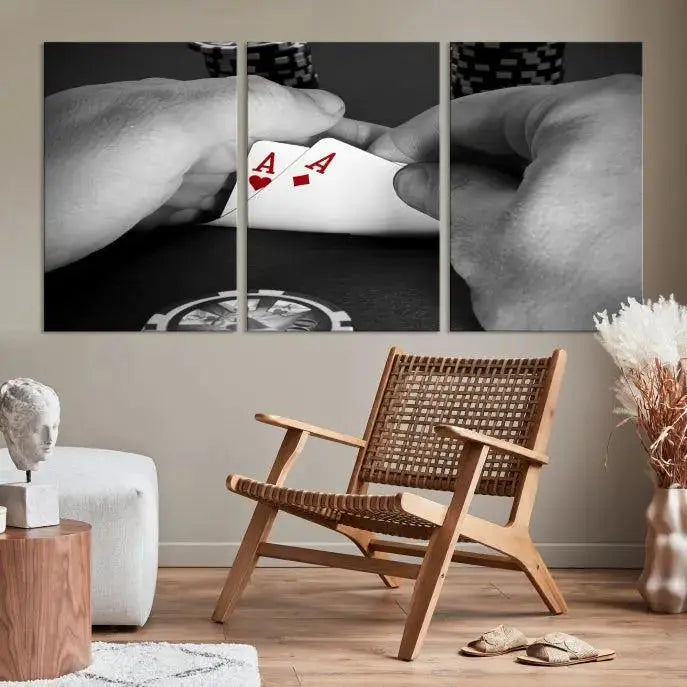 The living room wall is accentuated by the Ace of Hearts Poker Canvas Wall Art - Triptych Black and White Poker Hand Decor, ready to hang. This art piece captures a striking image of two hands holding a pair of aces, including the Ace of Hearts.