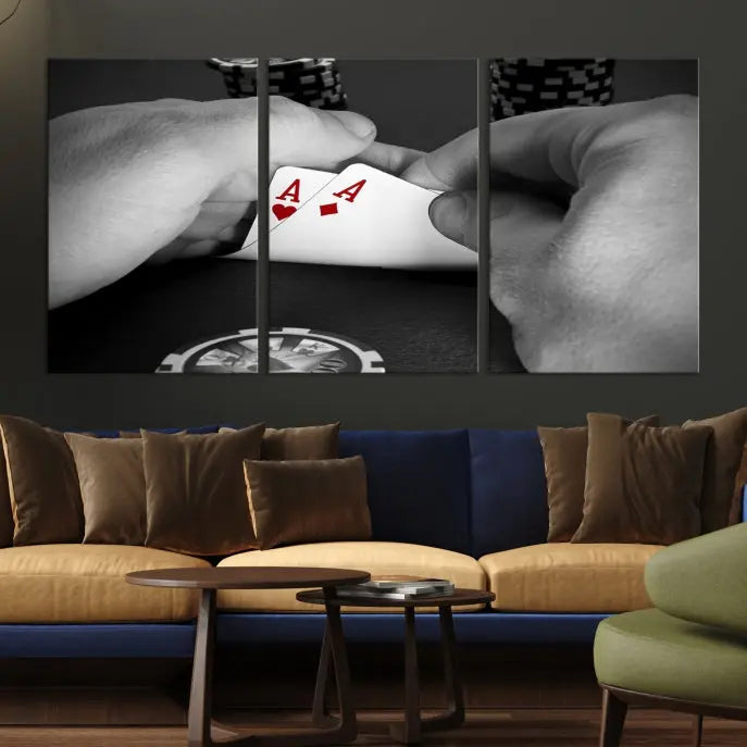 The living room wall is accentuated by the Ace of Hearts Poker Canvas Wall Art - Triptych Black and White Poker Hand Decor, ready to hang. This art piece captures a striking image of two hands holding a pair of aces, including the Ace of Hearts.