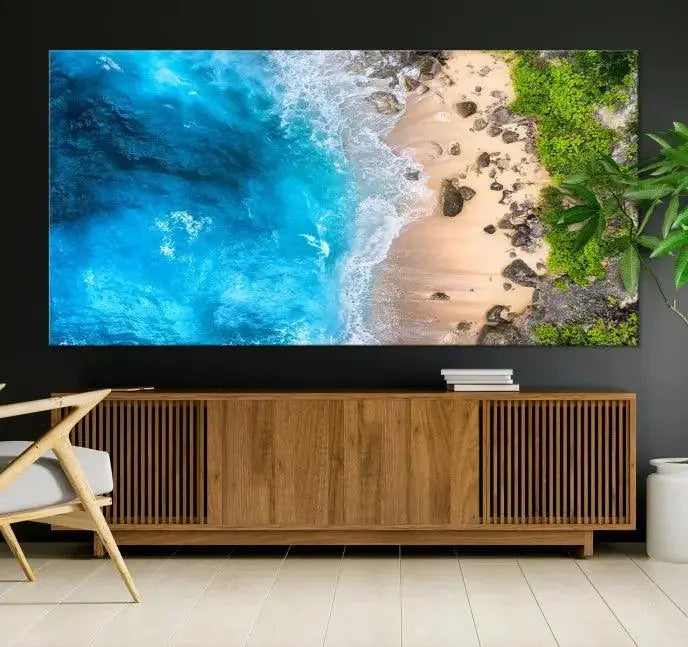 The Aerial Ocean Beach Canvas Wall Art Print is elegantly displayed, boasting a UV-protective coating to ensure enduring vibrancy. This museum-quality canvas piece is prepped for easy hanging.