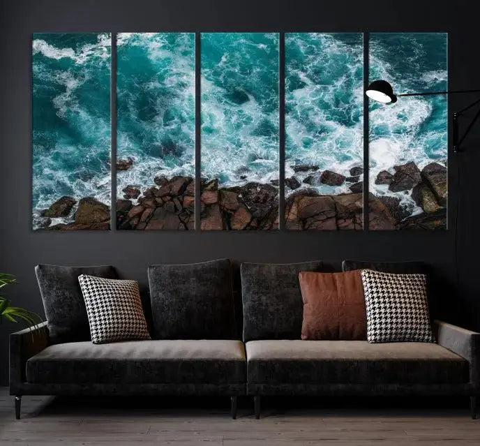 The Aerial Ocean Waves Wall Art Canvas Print is showcased on gallery-wrapped, museum-quality canvases, depicting a triptych of ocean waves crashing on rocks.