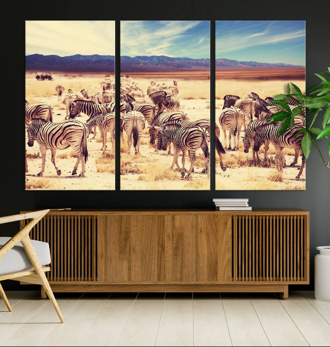 The Africa Zebras in the Savannah Canvas Wall Art Print features a zebra triptych on museum-quality canvas. This gallery-wrapped artwork is finished with a UV-protective coating, ensuring lasting vibrancy and elegance.