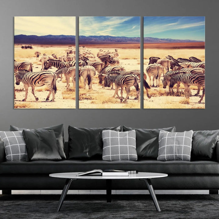 The Africa Zebras in the Savannah Canvas Wall Art Print features a zebra triptych on museum-quality canvas. This gallery-wrapped artwork is finished with a UV-protective coating, ensuring lasting vibrancy and elegance.